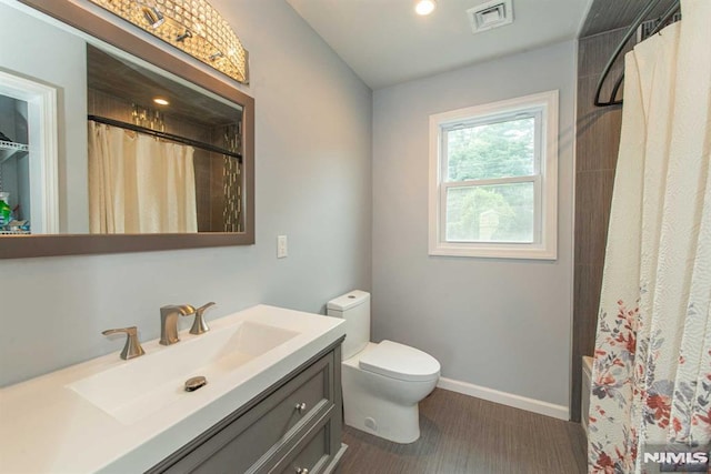 bathroom with toilet and vanity