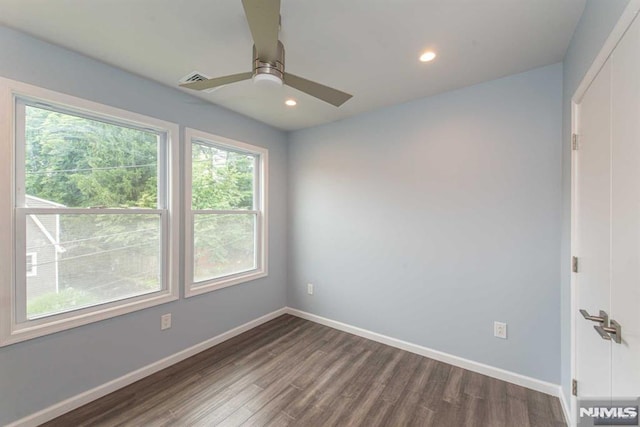 unfurnished room with ceiling fan and dark hardwood / wood-style floors