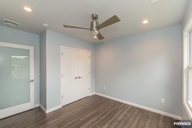 unfurnished bedroom with a closet, ceiling fan, and dark hardwood / wood-style floors