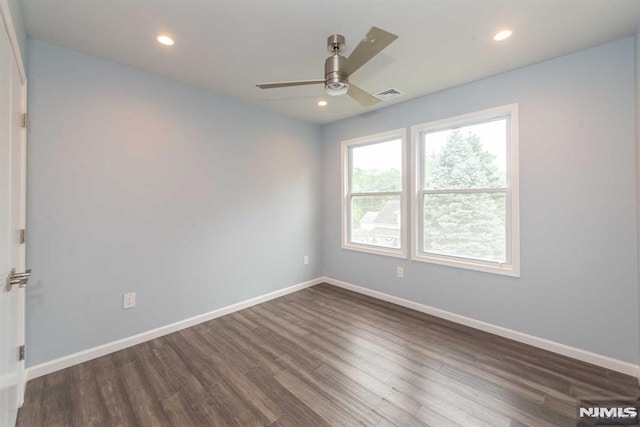 unfurnished room featuring dark hardwood / wood-style flooring and ceiling fan