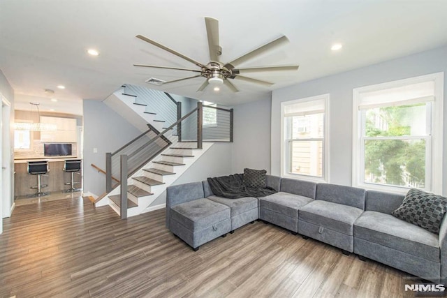 living room with hardwood / wood-style flooring and ceiling fan