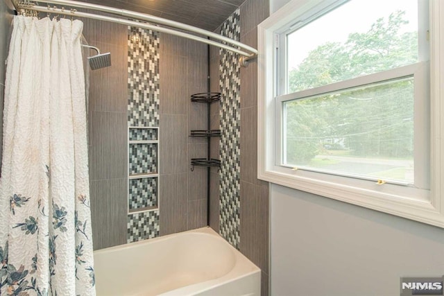 bathroom featuring shower / bathtub combination with curtain