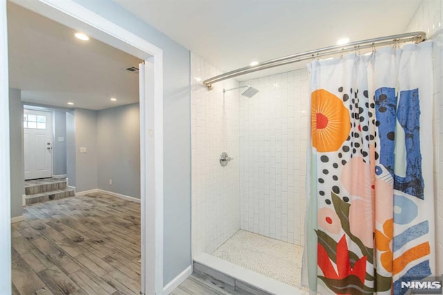 bathroom featuring walk in shower and hardwood / wood-style flooring