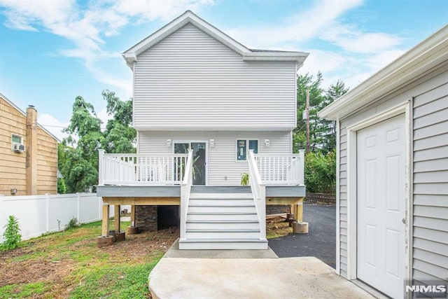 back of property featuring a deck