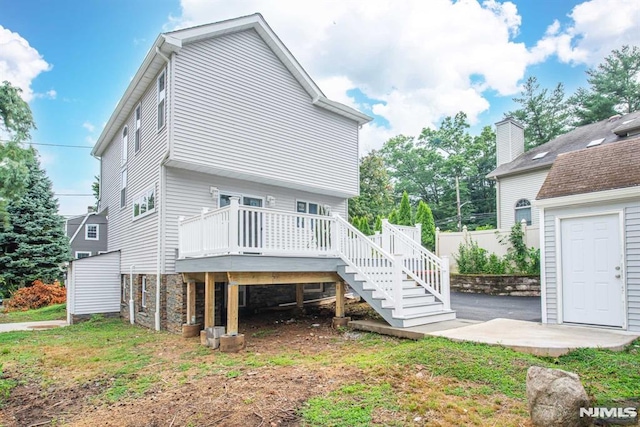 rear view of property with a patio area and a wooden deck