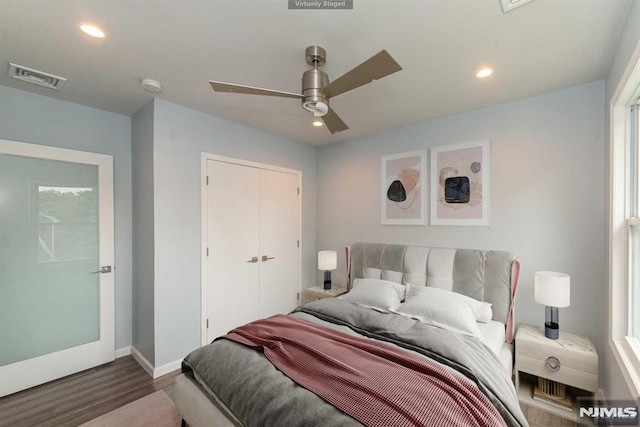 bedroom featuring ceiling fan, a closet, and wood-type flooring