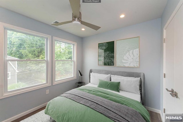 bedroom with wood-type flooring and ceiling fan