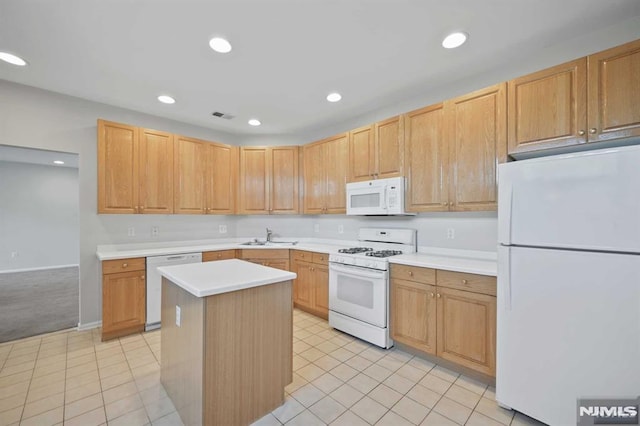 kitchen with sink, light brown cabinets, white appliances, light tile patterned floors, and a kitchen island