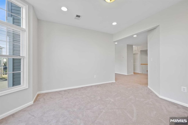 spare room with light colored carpet