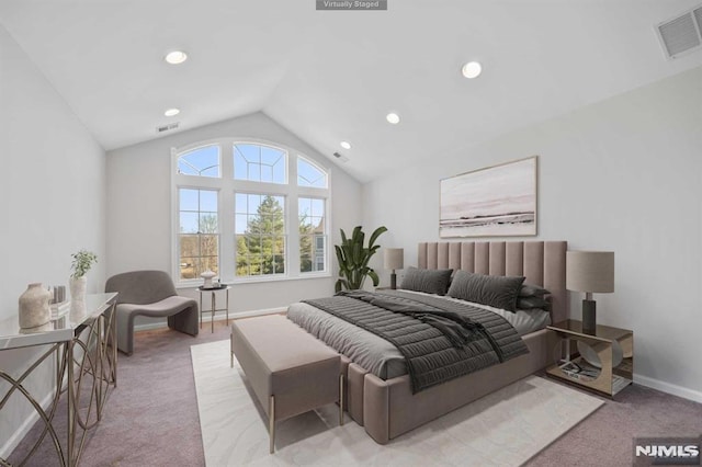 bedroom featuring vaulted ceiling and light colored carpet