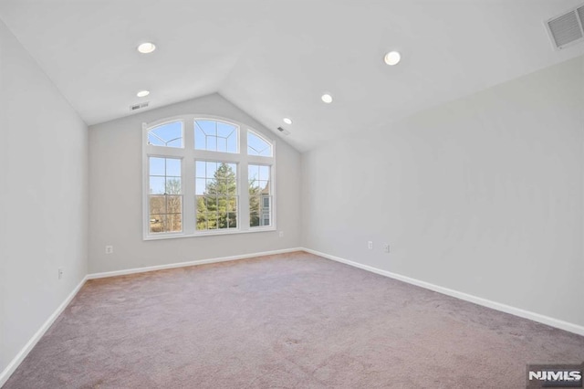 bonus room with lofted ceiling and carpet flooring