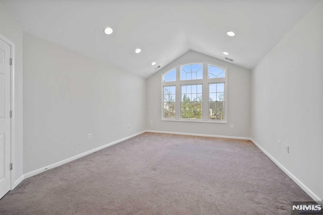 interior space featuring vaulted ceiling and carpet flooring