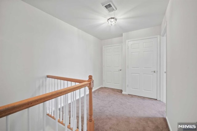 corridor with light colored carpet