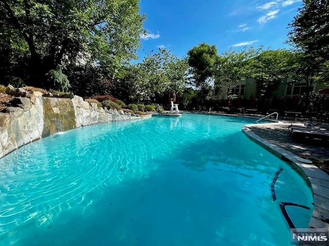 view of swimming pool featuring pool water feature