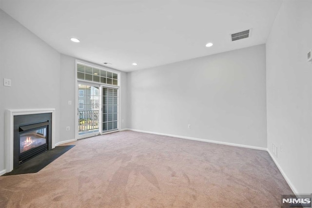 unfurnished living room with dark carpet