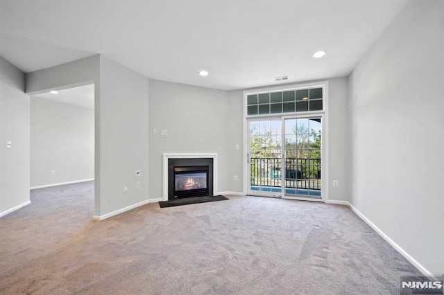 unfurnished living room featuring carpet