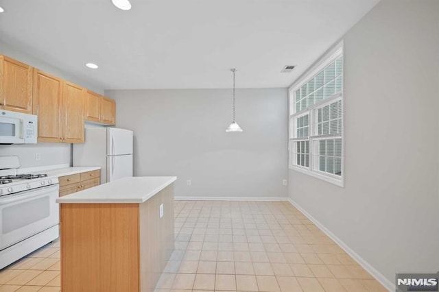 kitchen with white appliances, hanging light fixtures, light tile patterned floors, light brown cabinetry, and a kitchen island