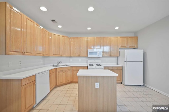 kitchen with white appliances, light tile patterned floors, a kitchen island, light brown cabinets, and sink