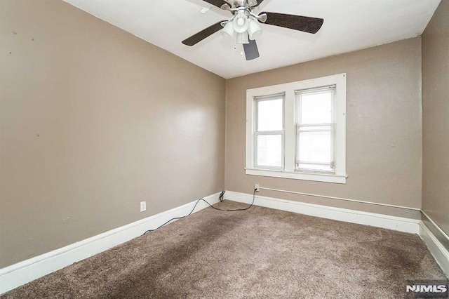 empty room with ceiling fan and carpet floors