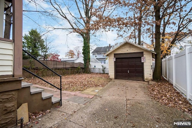 view of yard featuring a garage and an outbuilding