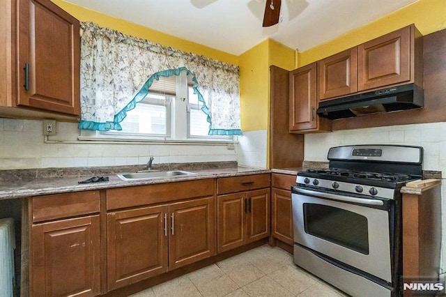 kitchen with sink, ceiling fan, and stainless steel gas range