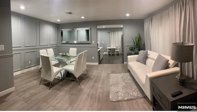 dining space with wood-type flooring