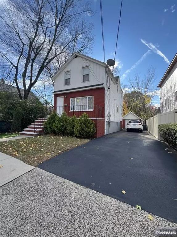 view of home's exterior with a garage and an outbuilding