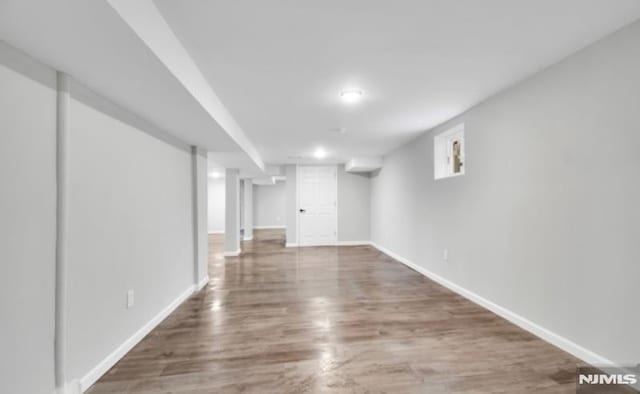 basement with dark wood-type flooring