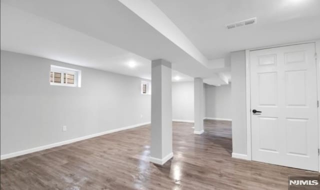 basement featuring dark hardwood / wood-style flooring