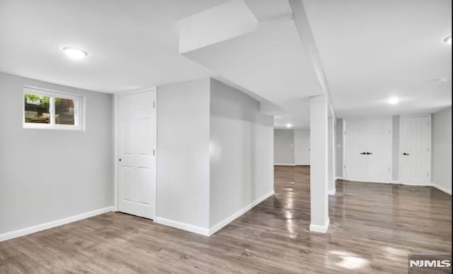 basement featuring hardwood / wood-style floors