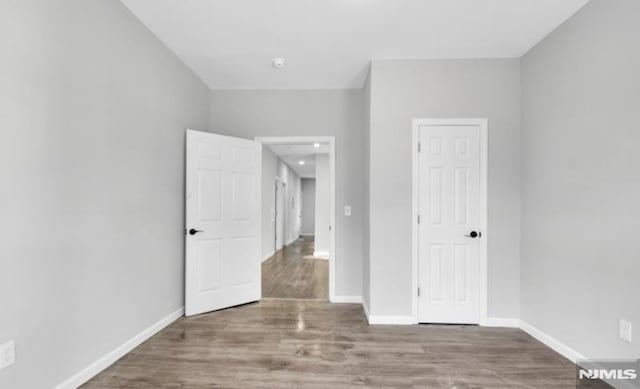 unfurnished bedroom featuring hardwood / wood-style flooring