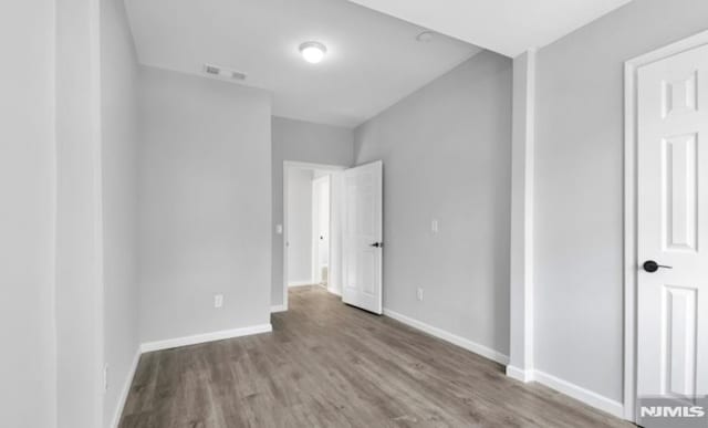 unfurnished bedroom featuring hardwood / wood-style flooring