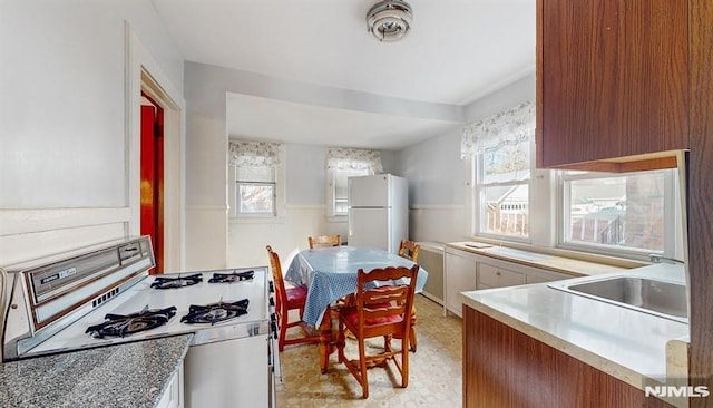 kitchen featuring white appliances and sink