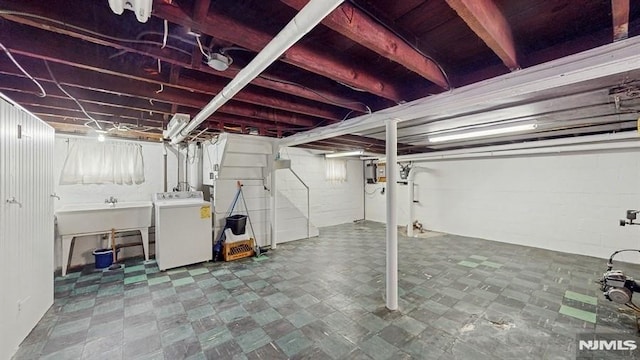 basement featuring sink and washer / clothes dryer