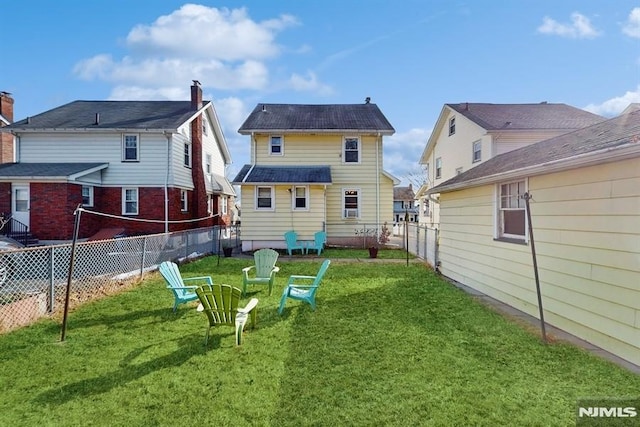 rear view of house featuring a yard