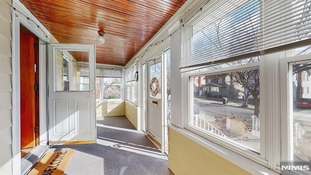 unfurnished sunroom with wood ceiling