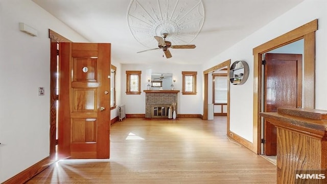 hall with light hardwood / wood-style floors and radiator