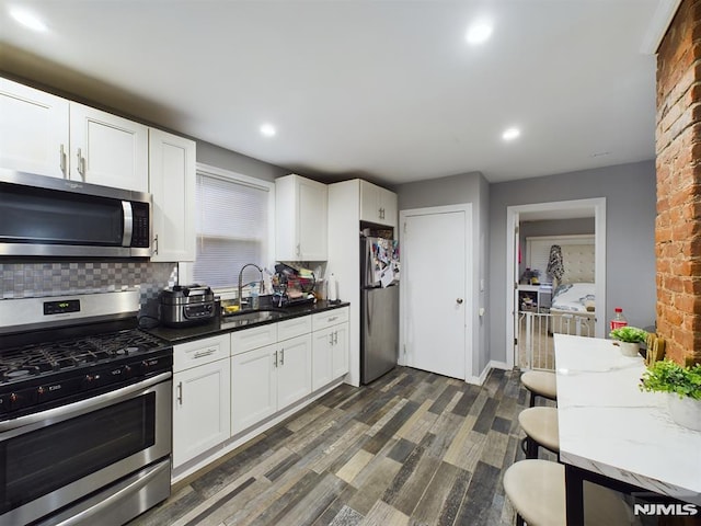 kitchen featuring sink, stainless steel appliances, and white cabinetry