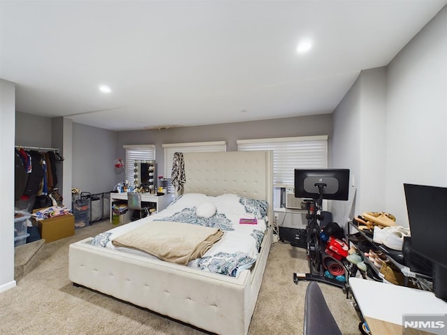 bedroom with light colored carpet and a closet