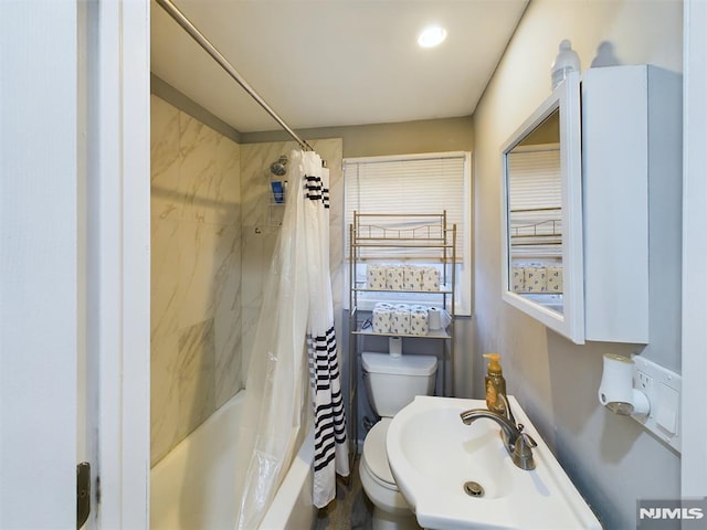 full bathroom with toilet, shower / bath combination with curtain, and sink