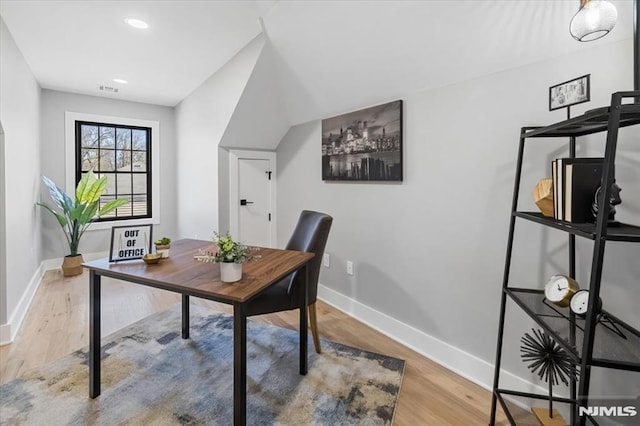 office area featuring visible vents, baseboards, and wood finished floors