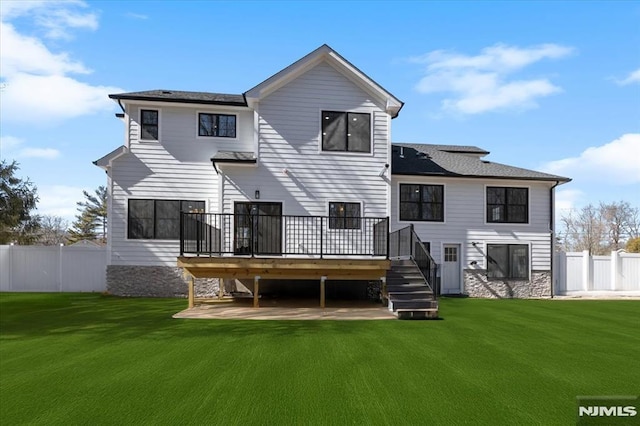 back of property featuring stairs, a yard, fence, and a wooden deck