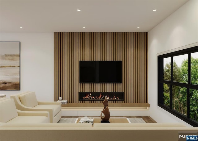 living room featuring a large fireplace and recessed lighting