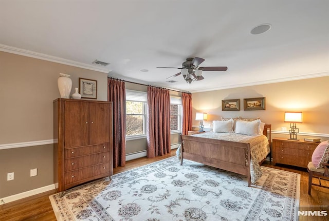 bedroom featuring ornamental molding, ceiling fan, a baseboard radiator, and hardwood / wood-style floors