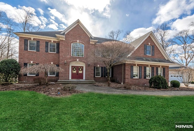 view of front facade featuring a garage, french doors, and a front yard