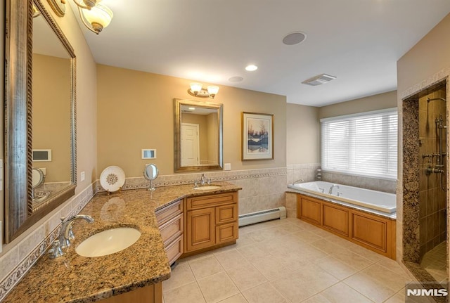 bathroom featuring tile patterned flooring, tile walls, a baseboard radiator, independent shower and bath, and vanity