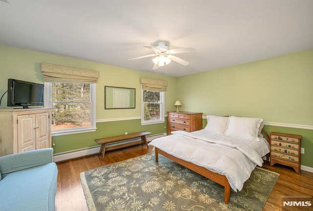 bedroom featuring ceiling fan, a baseboard radiator, and dark hardwood / wood-style flooring