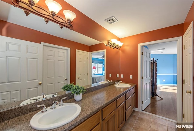 bathroom featuring tile patterned flooring and vanity