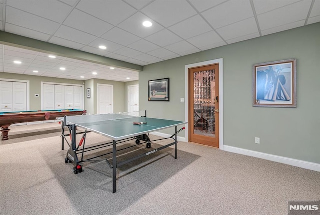 recreation room with pool table, a paneled ceiling, and carpet flooring