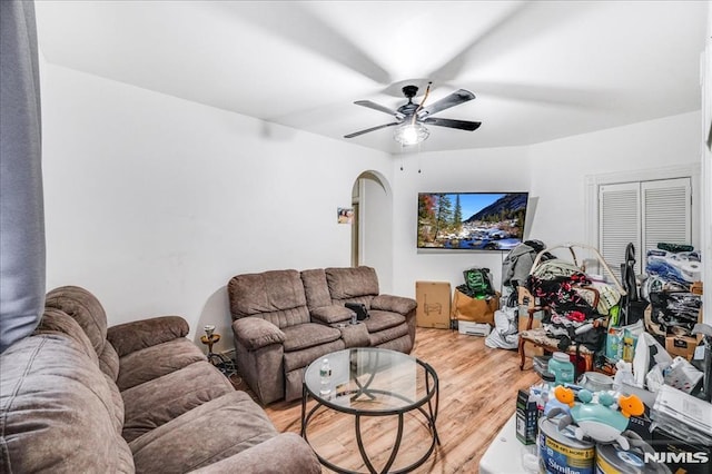 living room featuring ceiling fan and hardwood / wood-style floors